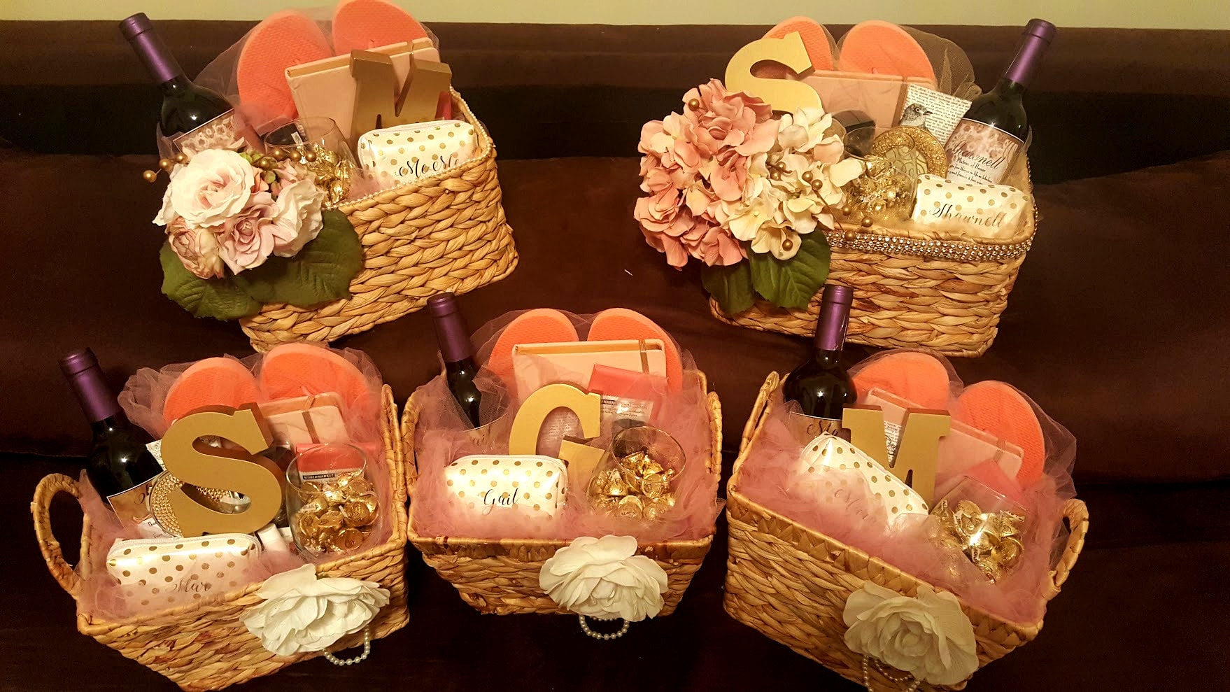 Personalized bridesmaid gift baskets with monogram letters, wine, and flowers
