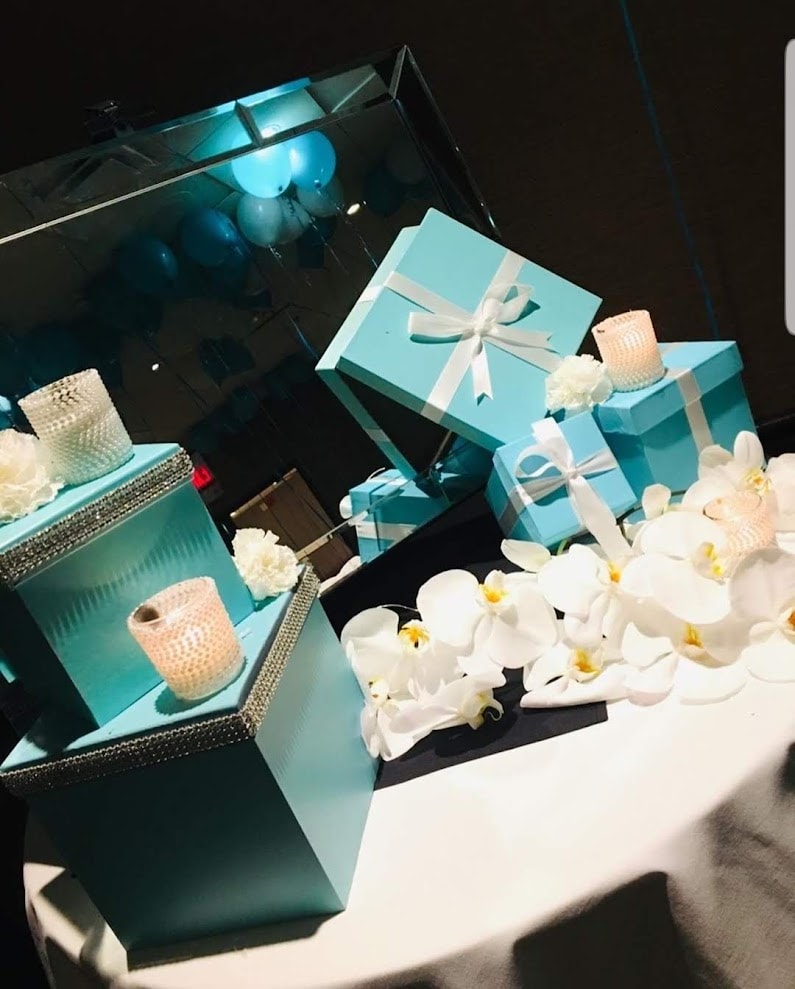 Tiffany blue gift boxes with white orchids and crystal candles on event table