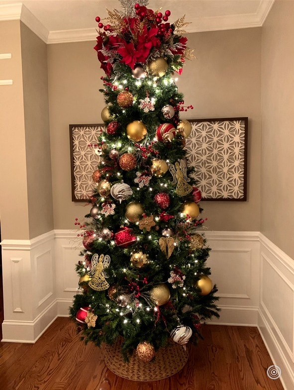 Tall red and gold Christmas tree with angel ornaments