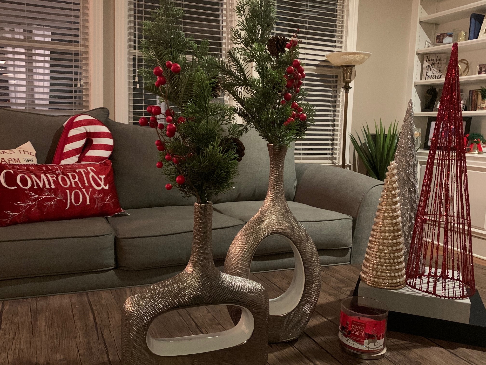 Comfort and Joy holiday living room with sculptural vases and red berry branches
