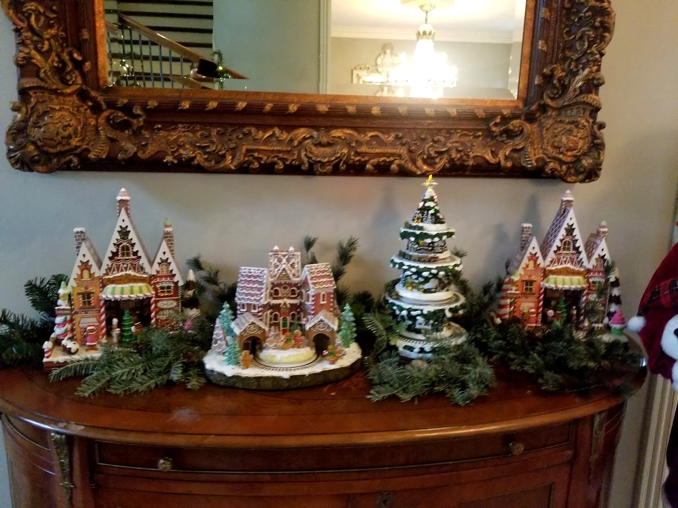 Gingerbread village display on antique dresser