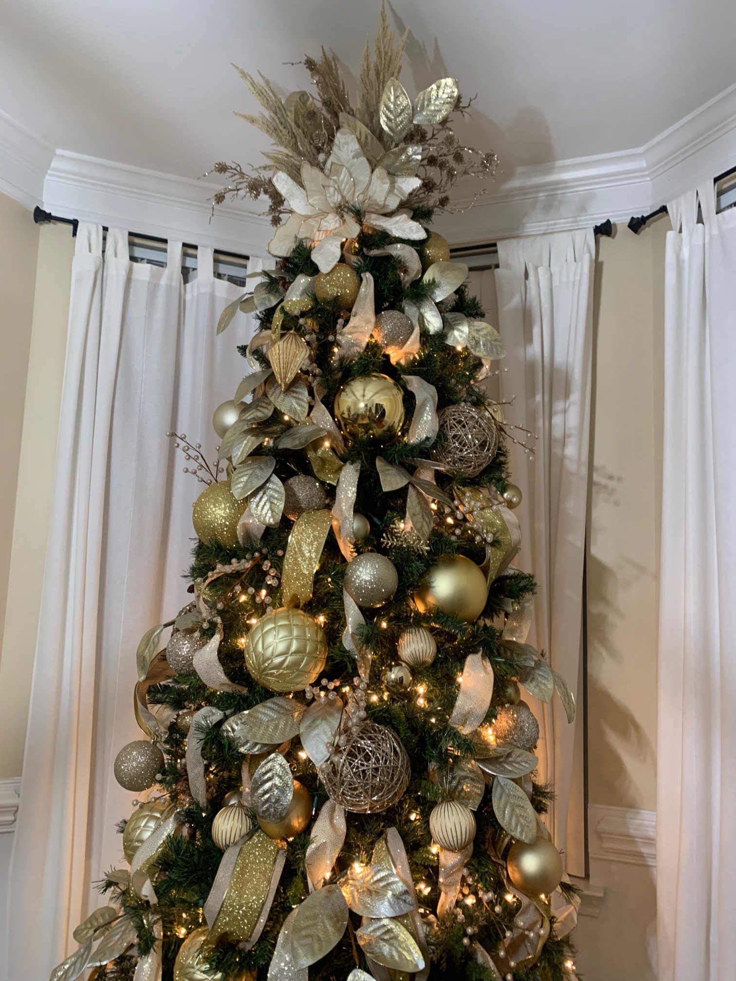 Lush gold and champagne garland with ornaments over mantel