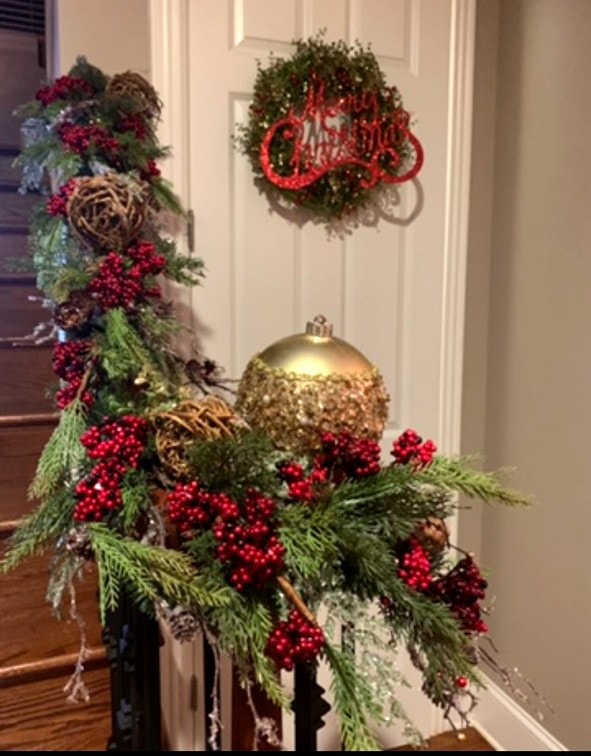 Staircase newel post with Merry Christmas wreath